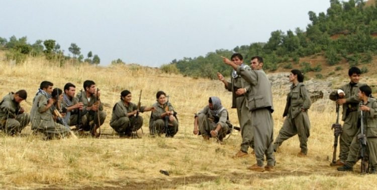 Guerrilla fighters of the PKK (Kurdistan Worker's Party) listen to instructions from their team commander during a training session in a camp near Arbil in the Haqourqi mountains, northern Iraq, 11 August 2005. The PKK, which has stepped up violence in Turkey's mainly Kurdish southeast over the past few months, retreated to northern Iraq after a unilateral ceasefire it declared in 1999 in its war with Ankara. The militants began sneaking back after they called off the truce in June 2004. The Kurdish conflict in Turkey has claimed some 37,000 lives since 1984 when the PKK took up arms for Kurdish self-rule in the country's southeast. AFP PHOTO/Mustafa Ozer