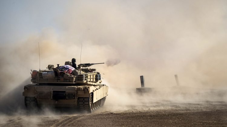 Dust rises as a tank from the Iraqi army's 9th armoured division fires at a suspect car approaching their position in the area of Ali Rash, adjacent to the eastern Al-Intissar neighbourhood of Mosul, on November 6, 2016, during a military operation to retake the main hub city from the Islamic State (IS) group jihadists.
Iraqi forces battled jihadists inside Mosul for the third day running while civilians risked their lives dodging bombs and snipers to slip out of the city. / AFP / Odd ANDERSEN / ALTERNATIVE CROP (Photo credit should read ODD ANDERSEN/AFP/Getty Images)