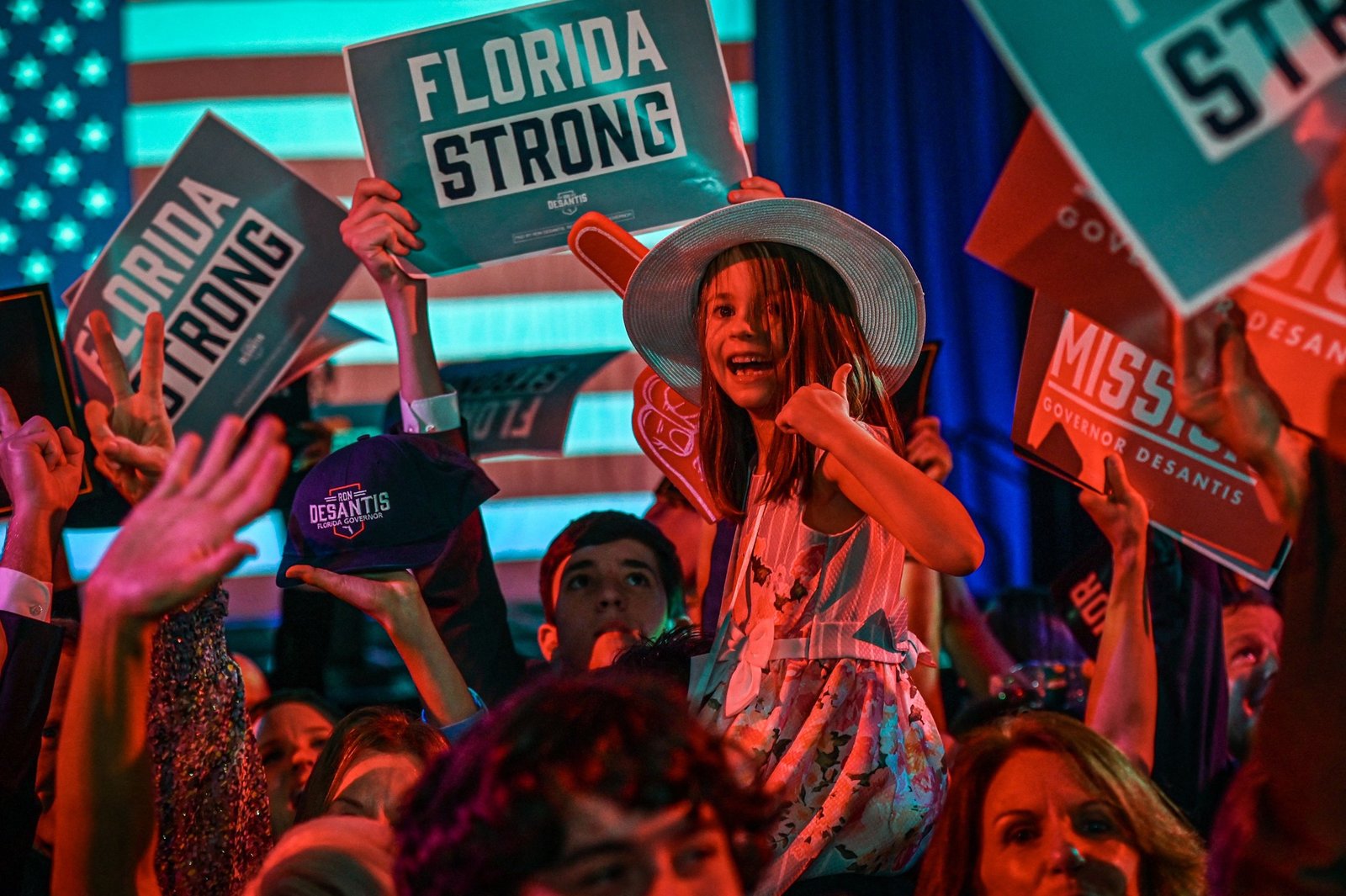 Supporters of Republican gubernatorial candidate for Florida Ron DeSantis cheer during an election night watch party at the Convention Center in Tampa, Florida, on November 8, 2022. - Florida Governor Ron DeSantis, who has been tipped as a possible 2024 presidential candidate, was projected as one of the early winners of the night in Tuesday's midterm election. (Photo by Giorgio VIERA / AFP)