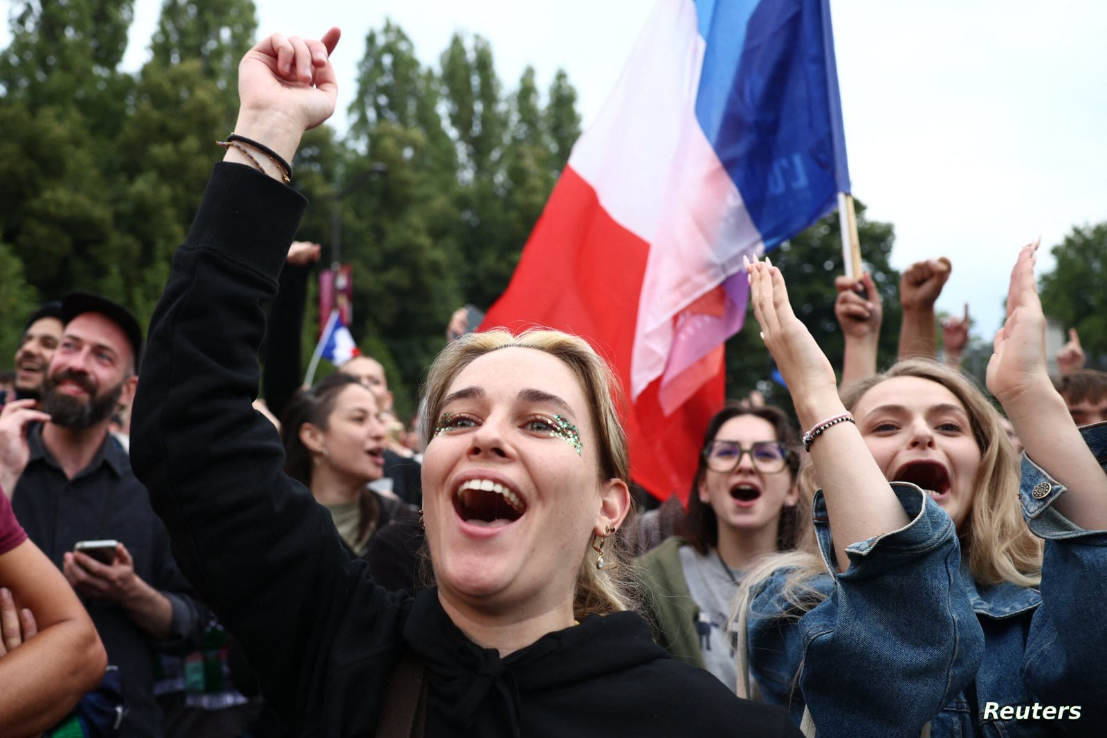 Supporters of French far-left opposition party La France Insoumise (France Unbowed - LFI) react after partial results in the second round of the early French parliamentary elections at Place Stalingrad in Paris, France, July 7, 2024. REUTERS/Yara Nardi